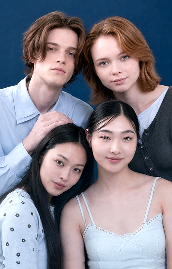 Four smiling young guests