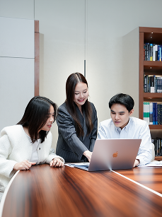 Team members working at a laptop