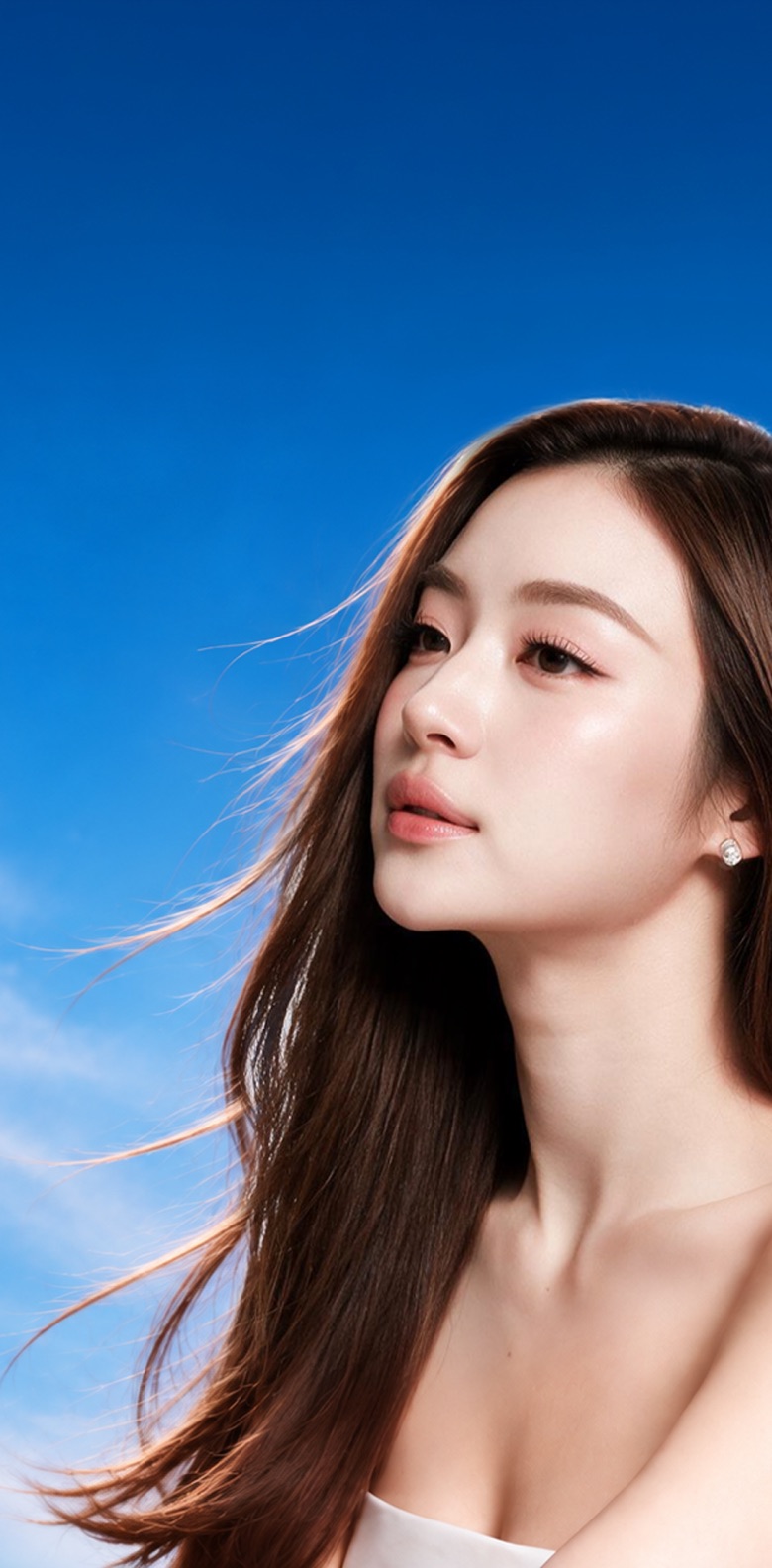 A woman with long hair against a blue sky